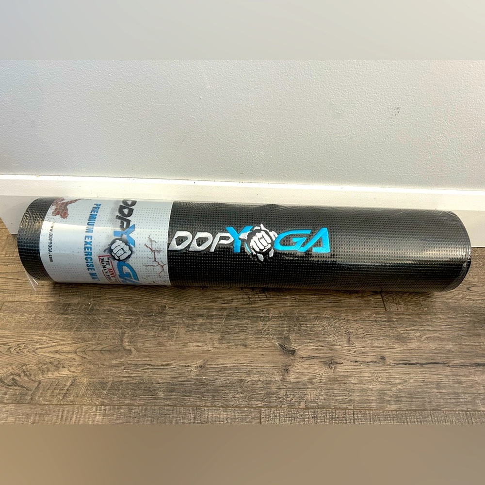 Brand new DDP yoga mat. In original packaging.